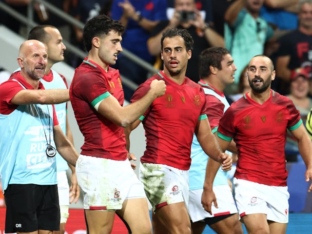 Portugal's Raffaele Storti celebrates scoring their first try with Manuel Cardoso Pinto and head coach Patrice Lagisquet on October 8, 2023