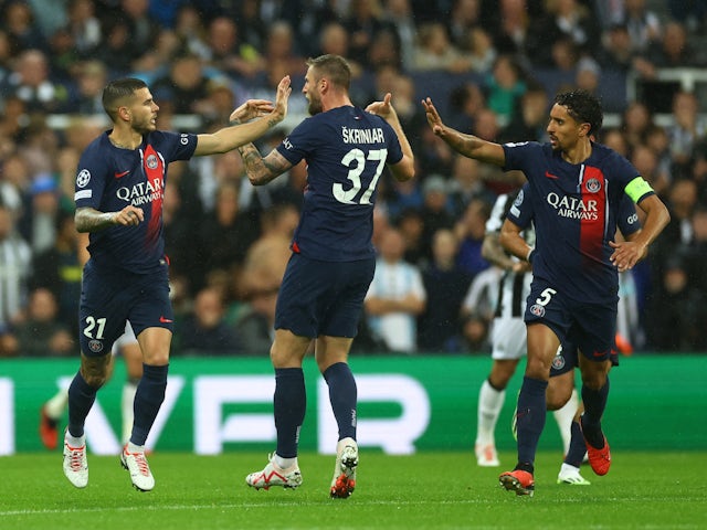 Paris Saint-Germain's (PSG's) Lucas Hernandez celebrates scoring their first goal with Milan Skriniar and Marquinhos on October 4, 2023