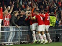 PSV Eindhoven's Jordan Teze celebrates scoring their second goal with teammates and fans on October 4, 2023