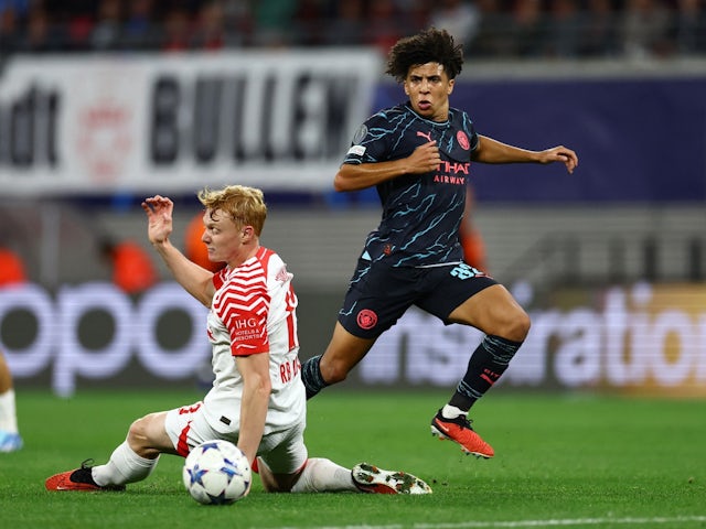 Manchester City's Rico Lewis in action with RB Leipzig's Nicolas Seiwald on October 4, 2023
