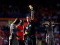 Tottenham Hotspur's Yves Bissouma is shown a red card by referee John Brooks on October 7, 2023