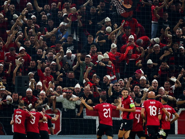 Albania's Jasir Asani celebrates scoring their first goal with teammates on October 12, 2023