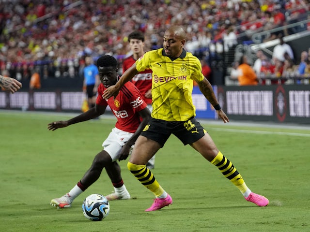 Borussia Dortmund forward Donyell Malen in action with Manchester United midfielder Omari Forson on July 30, 2023
