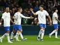 Greece's Georgios Masouras celebrates scoring their second goal with Dimitris Pelkas and Konstantinos Mavropanos on October 13, 2023