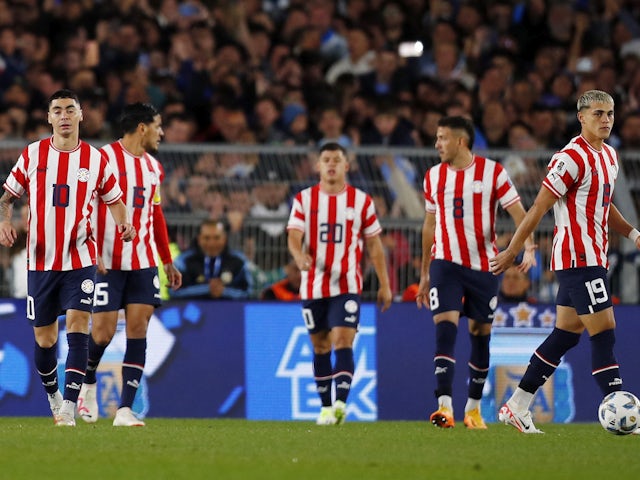 Paraguay's Miguel Almiron and teammates look dejected after Argentina's Nicolas Otamendi scores their first goal on October 13, 2023