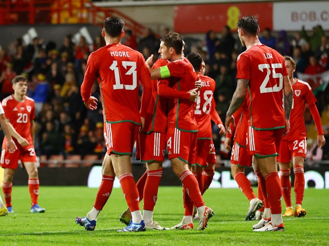Wales' Ben Davies celebrates scoring their first goal with teammates on October 11, 2023