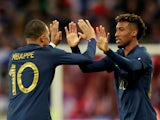 France's Kingsley Coman celebrates scoring their fourth goal with Kylian Mbappe on October 17, 2023