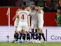 Sevilla players celebrate after Real Madrid's David Alaba scores an own goal and the first for Sevilla on October 21, 2023