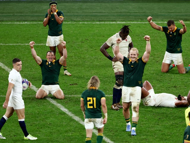 South Africa's Vincent Koch, Deon Fourie and teammates celebrate after the match on October 21, 2023