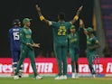 South Africa celebrate taking a wicket against England at the Cricket World Cup on October 21, 2023.