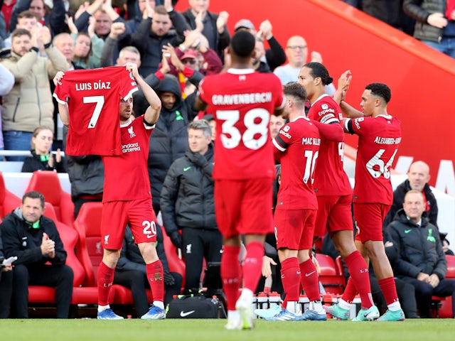 Liverpool's Diogo Jota holds up a Luis Diaz shirt after scoring their first goal on October 28, 2023