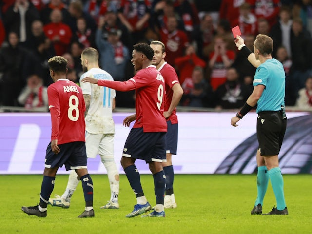 Slovan Bratislava's Lucas Lovat is shown a red card by referee Luca Pairetto on October 26, 2023