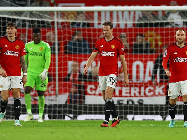 Manchester United's Jonny Evans, Victor Lindelof and Christian Eriksen react after Manchester City's Erling Braut Haaland scores their second goal on October 29, 2023