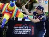 Max Verstappen attacks a pinata at the Mexican GP on October 26, 2023