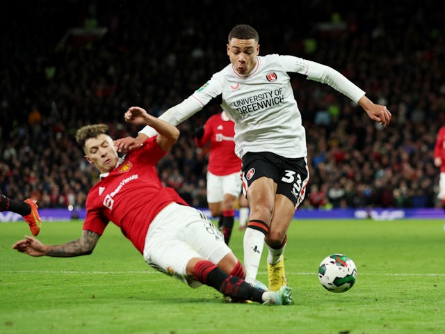 Manchester United's Lisandro Martinez in action with Charlton Athletic's Miles Leaburn in January 2023
