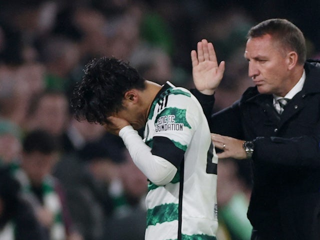 Celtic's Reo Hatate is patted on the back by manager Brendan Rodgers as he looks dejected after being substituted off due to sustaining an injury on October 25, 2023