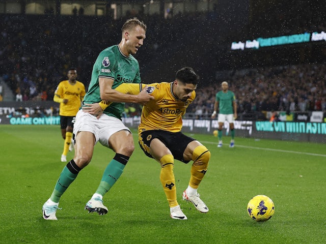 Wolverhampton Wanderers' Pedro Neto in action with Newcastle United's Dan Burn on October 28, 2023