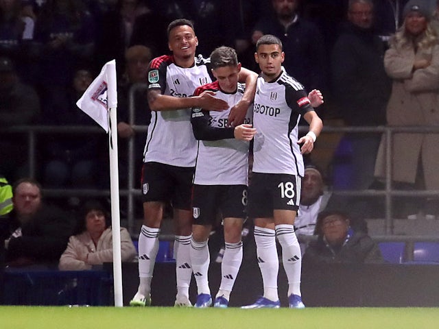 Fulham's Harry Wilson celebrates scoring their first goal with Andreas Pereira and Rodrigo Muniz on November 1, 2023