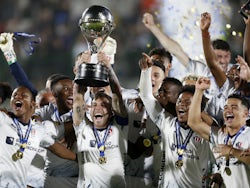 Liga de Quito's Ezequiel Piovi lifts the trophy with teammates after winning the Copa Sudamericana on October 29, 2023