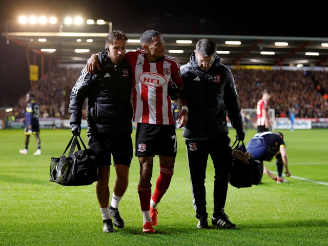 Exeter City's Demetri Mitchell goes off injured on October 31, 2023