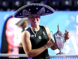 Iga Swiatek poses with the trophy after winning the WTA Finals on November 6, 2023