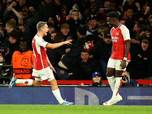 Arsenal's Leandro Trossard celebrates scoring their first goal with Bukayo Saka on November 8, 2023