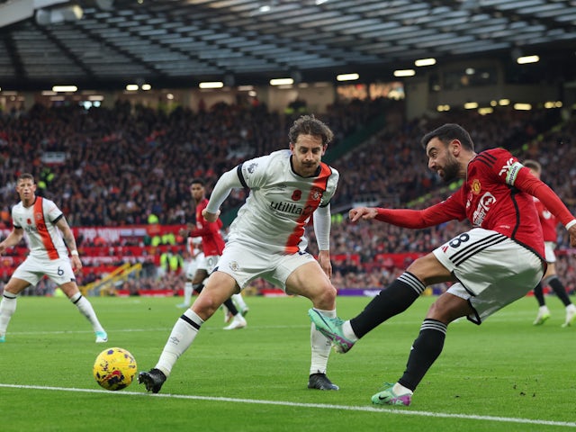 Luton Town's Tom Lockyer in action with Manchester United's Bruno Fernandes on November 11, 2023