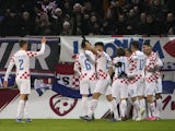 Croatia's Lovro Majer celebrates scoring their first goal with teammates on November 18, 2023
