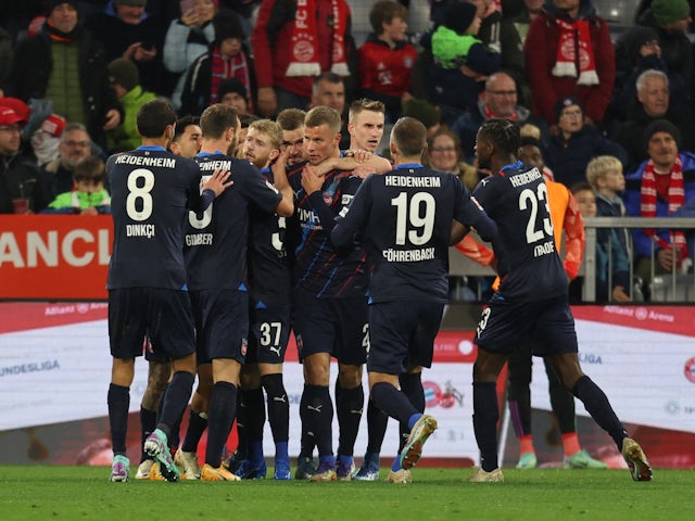 Heidenheim's Jan-Niklas Beste celebrates scoring their second goal with teammates on November 11, 2023