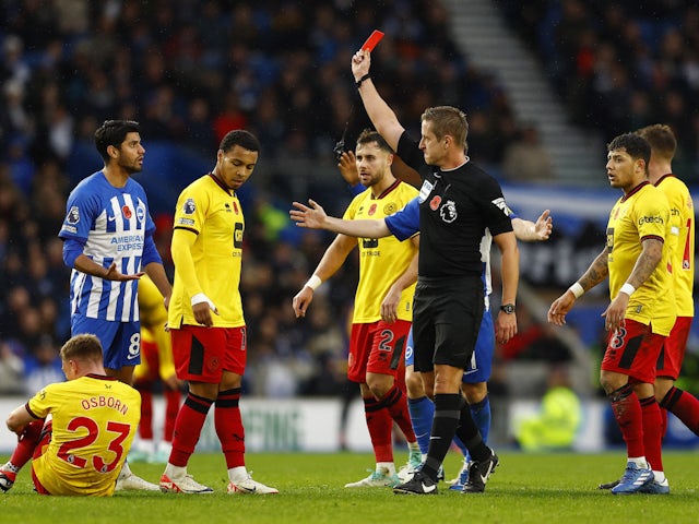 Brighton & Hove Albion's Mahmoud Dahoud is shown a red card by referee John Brooks on November 12, 2023