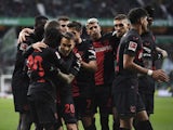 Bayer Leverkusen's Jeremie Frimpong celebrates scoring their second goal with teammates on November 25, 2023