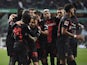 Bayer Leverkusen's Jeremie Frimpong celebrates scoring their second goal with teammates on November 25, 2023