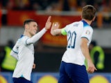 England's Harry Kane and Phil Foden celebrate their first goal an own goal scored by North Macedonia's Jani Atanasov on November 20, 2023