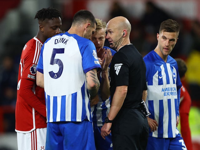 Brighton & Hove Albion's Lewis Dunk reacts after being shown a red card by referee Anthony Taylor on November 25, 2023