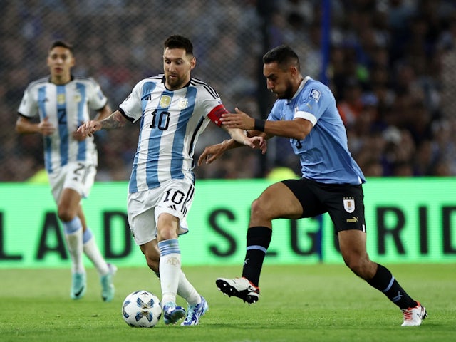 Argentina's Lionel Messi in action with Uruguay's Sebastian Caceres on November 16, 2023