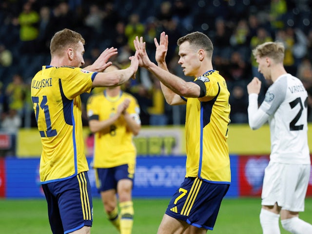 Sweden's Viktor Claesson celebrates scoring their first goal with Dejan Kulusevski on November 19, 2023