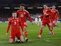 Wales' Neco Williams celebrates scoring their first goal with Ethan Ampadu and Connor Roberts on November 21, 2023