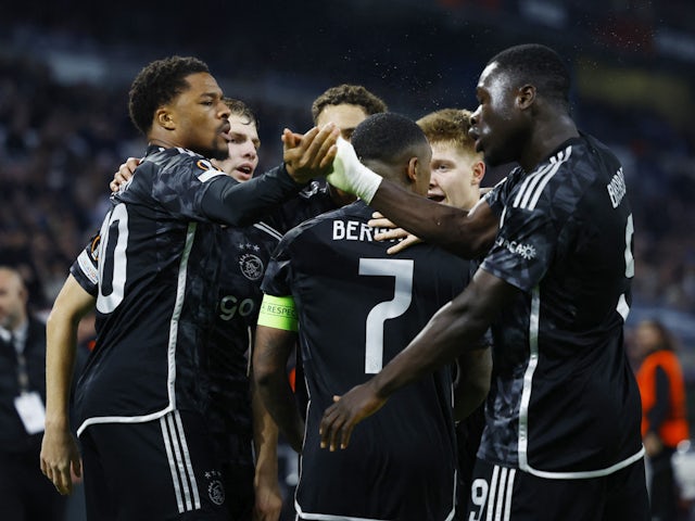 Ajax's Chuba Akpom celebrates scoring their third goal with teammates on November 30, 2023