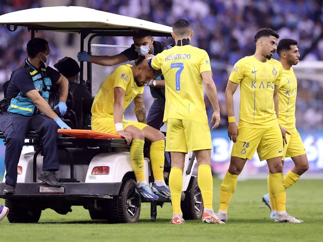 Al Nassr's Alex Telles is brought off the pitch after sustaining an injury on December 1, 2023