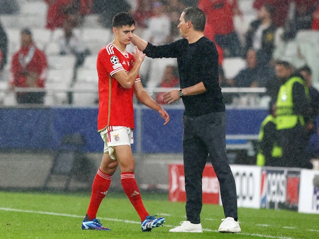 Benfica's Antonio Silva walks off the pitch after being sent off as coach Roger Schmidt looks on on November 29, 2023