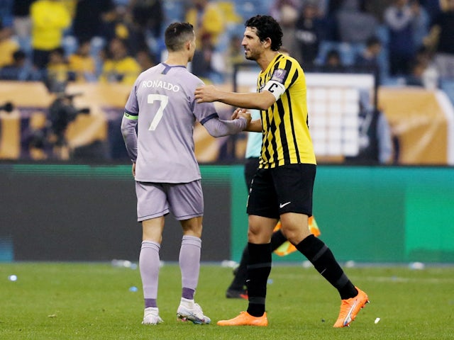 Al Nassr's Cristiano Ronaldo shakes hands with Al Ittihad's Ahmed Hegazy on January 26, 2023