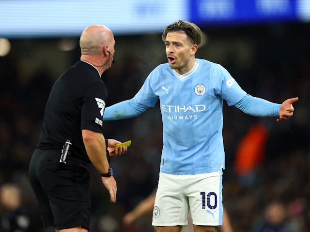 Manchester City's Jack Grealish remonstrates with referee Simon Hooper before being shown a yellow card on December 3, 2023