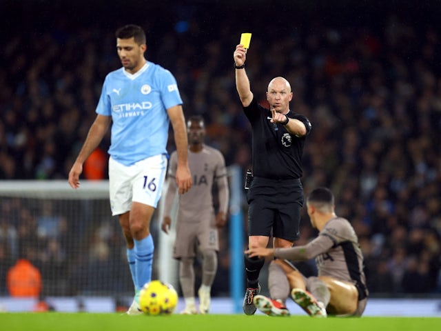 Manchester City's Rodri is shown a yellow card by referee Simon Hooper on December 3, 2023