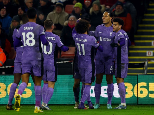Liverpool's Virgil van Dijk celebrates scoring their first goal with teammates on December 6, 2023