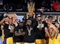 Los Angeles Lakers forward LeBron James (23) hoists the NBA Cup and celebrates with teammates after winning the NBA In-Season Tournament Championship on December 9, 2023