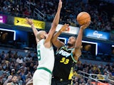 Indiana Pacers center Myles Turner (33) shoots while Boston Celtics guard Derrick White (9) defends on December 5, 2023