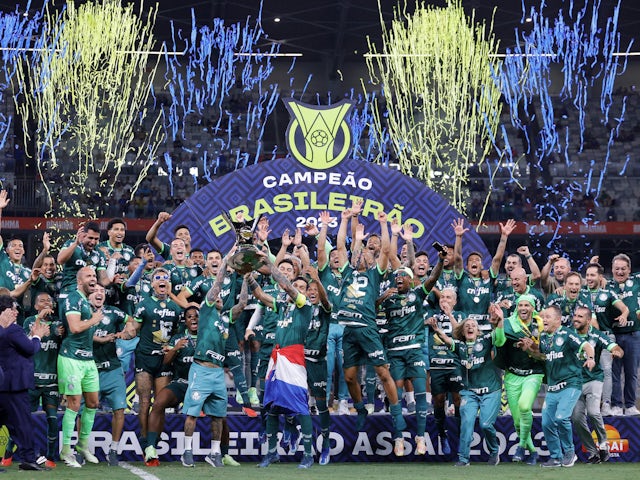Palmeiras players celebrate winning the Brasileiro Championship with the trophy on December 7, 2023