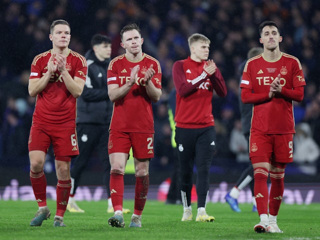 Aberdeen's Stefan Gartenmann, Nicky Devlin and Bojan Miovski look dejected as they applaud the fans after the match on December 17, 2023