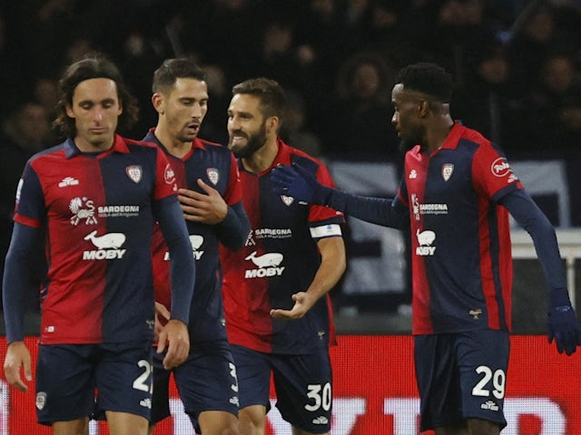 Cagliari's Leonardo Pavoletti celebrates scoring their first goal with teammates on December 16, 2023