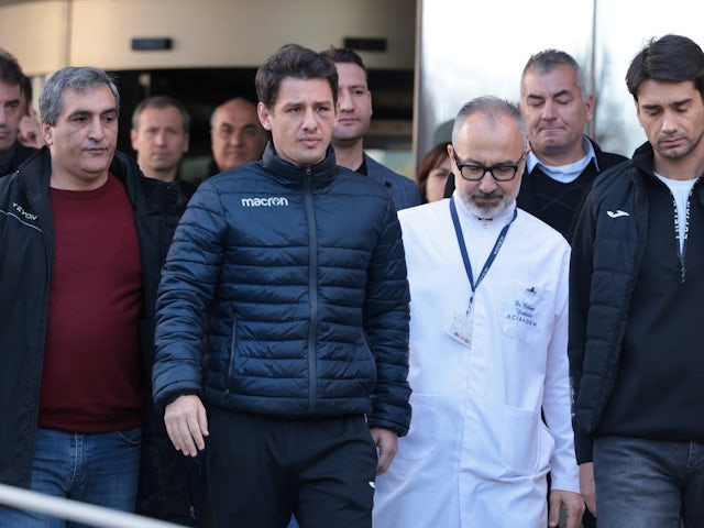 Turkish referee Halil Umut Meler, accompanied by head doctor Mehmet Yorubulut, leaves from a hospital in Ankara, Turkey on December 13, 2023